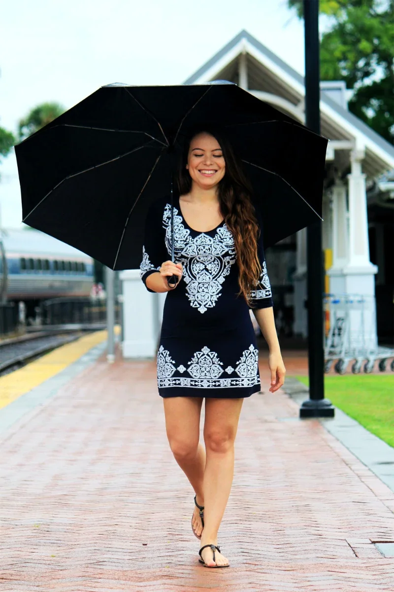 sylibi - happy woman walking with umbrella